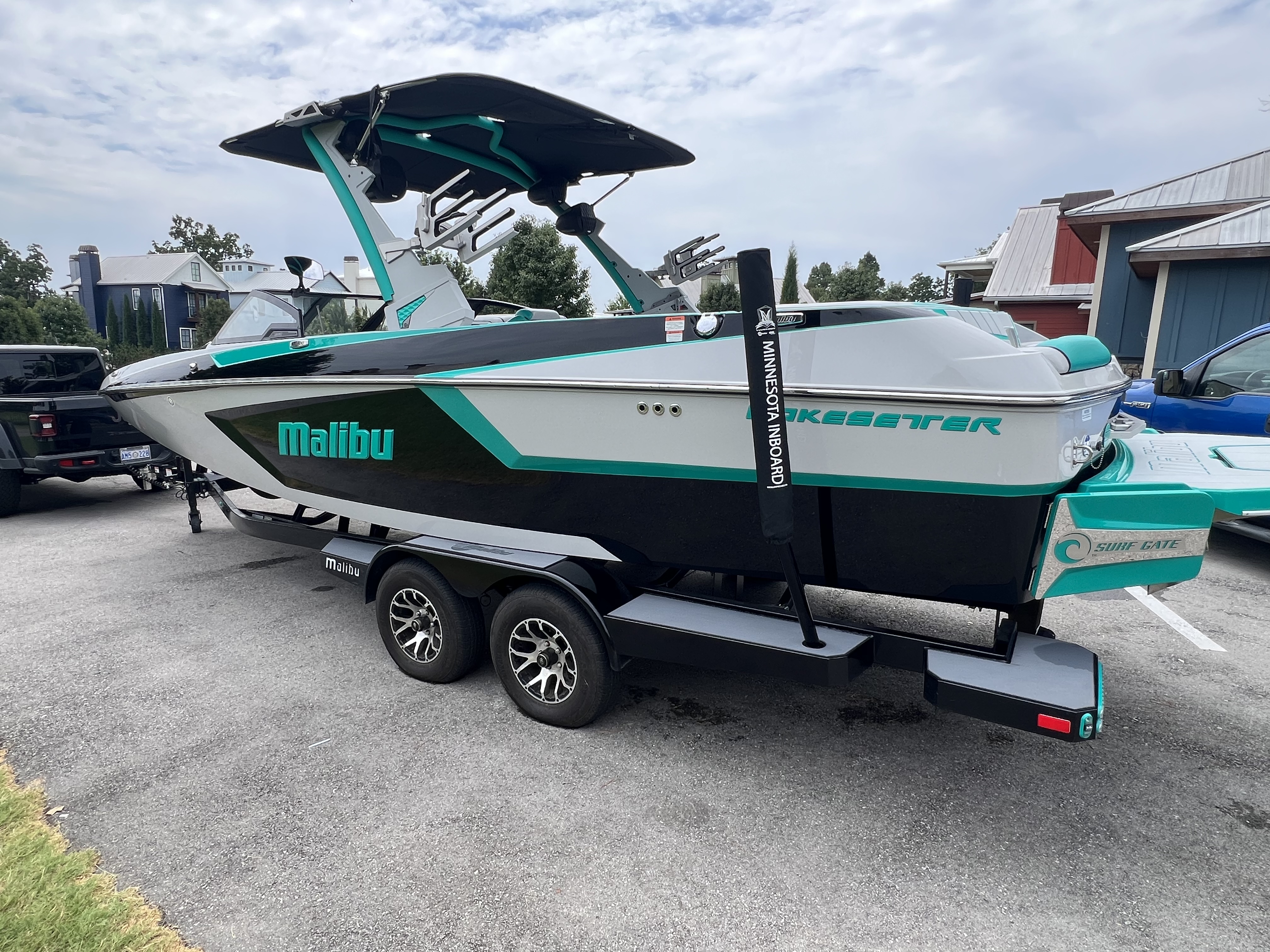 Detailed teal and white Malibu Wakesetter wake boat on its trailer